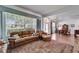 Living room featuring hardwood floors, a large window, comfortable furniture, and a stylish rug at 8749 Ashworth Dr, Tampa, FL 33647