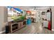Living Room with large TV, wood-look floors, and coastal decor at 10038 62Nd N Ter # 2, St Petersburg, FL 33708