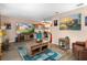 Living room with large TV, wood-look floors, and coastal decor at 10038 62Nd N Ter # 2, St Petersburg, FL 33708