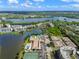 Aerial view of community with waterfront, pool, and tennis court at 10038 62Nd N Ter # 2, St Petersburg, FL 33708