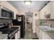 Bright kitchen with stainless steel appliances and light cabinets at 10038 62Nd N Ter # 2, St Petersburg, FL 33708