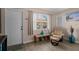 Living room with comfy chair and large window at 10038 62Nd N Ter # 2, St Petersburg, FL 33708