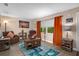 Living room with wood-look flooring, orange curtains, and comfy furniture at 10038 62Nd N Ter # 2, St Petersburg, FL 33708
