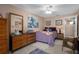 Cozy bedroom with wood dresser and purple bedding at 10038 62Nd N Ter # 2, St Petersburg, FL 33708