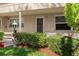 Ground floor entry with decorative lamp and landscaping at 10038 62Nd N Ter # 2, St Petersburg, FL 33708