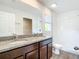 Double vanity bathroom with granite countertops and dark brown cabinets at 12128 Grouse Ave, Port Charlotte, FL 33981