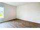 Spacious bedroom with wood-look flooring and large window at 12128 Grouse Ave, Port Charlotte, FL 33981