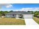 Single-story home with gray exterior and a two-car garage at 12128 Grouse Ave, Port Charlotte, FL 33981