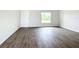 Living room with wood-look floors and white door at 12128 Grouse Ave, Port Charlotte, FL 33981