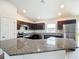 Modern kitchen with island, granite countertops, and stainless steel appliances at 12128 Grouse Ave, Port Charlotte, FL 33981
