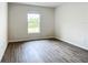 Simple bedroom with neutral walls and wood-look vinyl flooring at 12128 Grouse Ave, Port Charlotte, FL 33981