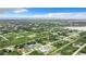 Aerial view of a residential neighborhood with houses and lush vegetation at 12128 Grouse Ave, Port Charlotte, FL 33981