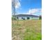 House exterior view, showcasing a large backyard at 12128 Grouse Ave, Port Charlotte, FL 33981