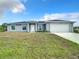 New construction home with gray siding and a two-car garage at 12128 Grouse Ave, Port Charlotte, FL 33981