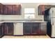 Kitchen with dark brown cabinets, granite countertops, and stainless steel appliances at 12128 Grouse Ave, Port Charlotte, FL 33981