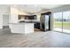 Open living room and kitchen with wood-look floors at 12128 Grouse Ave, Port Charlotte, FL 33981
