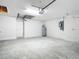 Unfinished garage with concrete floor and opener at 12128 Grouse Ave, Port Charlotte, FL 33981