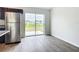 Kitchen with stainless steel refrigerator and sliding glass door to backyard at 12128 Grouse Ave, Port Charlotte, FL 33981