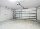 Unfinished garage with concrete floor and overhead door at 12128 Grouse Ave, Port Charlotte, FL 33981