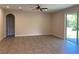Living room with tile flooring, a ceiling fan and sliding glass doors at 4506 Georgia Ave, North Port, FL 34288