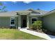 Front entrance of a house with a walkway and landscaping at 4506 Georgia Ave, North Port, FL 34288