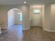 Bright and airy entryway with tile flooring, high ceilings, and views into the dining area at 4506 Georgia Ave, North Port, FL 34288
