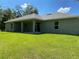 Rear view of a house showcasing a covered patio and spacious backyard at 4506 Georgia Ave, North Port, FL 34288