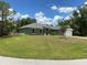 Single-story house with green exterior, landscaped lawn, and attached garage at 4506 Georgia Ave, North Port, FL 34288