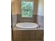 Bathroom featuring an oval bathtub and granite countertops at 4506 Georgia Ave, North Port, FL 34288