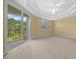 Bright bedroom with carpeted floors and private balcony access at 5242 Manorwood Dr # 3A, Sarasota, FL 34235