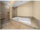 Bathroom with a large soaking tub and walk-in shower at 5242 Manorwood Dr # 3A, Sarasota, FL 34235