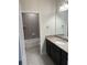 Bathroom with dark vanity, granite countertop, and a bathtub at 4619 Chamrade Rd, North Port, FL 34288