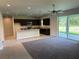 Open concept kitchen with island, dark cabinetry, and stainless steel appliances at 4619 Chamrade Rd, North Port, FL 34288