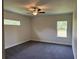 Spacious bedroom with carpet flooring and ceiling fan at 4619 Chamrade Rd, North Port, FL 34288