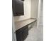 Laundry room with granite countertop and dark brown cabinets at 4619 Chamrade Rd, North Port, FL 34288