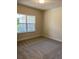 Spacious bedroom with large window and plush carpeting at 3481 Nashville Rd, North Port, FL 34288