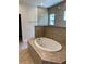 Bathroom with a large garden tub and tile shower surround at 3481 Nashville Rd, North Port, FL 34288