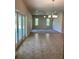 Open living and dining area with tile flooring and access to patio at 3481 Nashville Rd, North Port, FL 34288