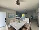 Open floor plan with modern kitchen and dining area, featuring white cabinets and quartz countertops at 12168 Van Gough Ave, Port Charlotte, FL 33981