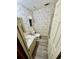 Small bathroom with floral wallpaper, vinyl floors, and a walk-in shower at 6480 Center Lane, North Port, FL 34287