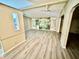 An open living room with wood floors and a ceiling fan that offers comfortable space at 6480 Center Lane, North Port, FL 34287