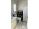 Clean bathroom with accessible toilet and storage at 6480 Center Lane, North Port, FL 34287