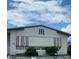 Mobile home with awning and landscaping,monogram on front at 6480 Center Lane, North Port, FL 34287