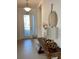 Bright entryway with tile floors, console table, and mirror at 3101 Hollow Hickory Pl, Wesley Chapel, FL 33543