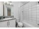 Clean bathroom with white tile, bathtub, and granite countertop at 3101 Hollow Hickory Pl, Wesley Chapel, FL 33543