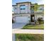 Two-story house with gray exterior, landscaping, and driveway at 3101 Hollow Hickory Pl, Wesley Chapel, FL 33543