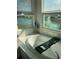 Bathroom with large soaking tub and window views at 3101 Hollow Hickory Pl, Wesley Chapel, FL 33543