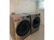 Laundry room with LG washer and dryer, and overhead shelving at 3101 Hollow Hickory Pl, Wesley Chapel, FL 33543