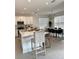 Open concept kitchen with white cabinets and large island at 3101 Hollow Hickory Pl, Wesley Chapel, FL 33543