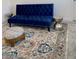 Living room featuring a blue velvet sofa and patterned rug at 3101 Hollow Hickory Pl, Wesley Chapel, FL 33543